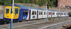 A photo of a Class 769 (769424) in Wigan Wallgate, blue is only present on the ends of the trains and on the doors.