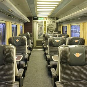 Looking down a First Class coach. This shows a 2+1 arrangement and the large Marilyn Munroe photo at the end.